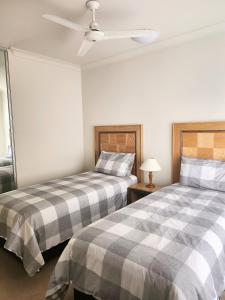 two beds sitting next to each other in a room at Unit 59 Seafront Estate in Jurien Bay