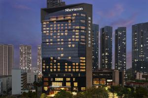 a tall building with a siegel corporation sign on it at Sheraton Shenzhen Nanshan in Shenzhen