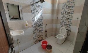 a bathroom with a toilet and a sink at FabHotel CM Palace I in Varanasi
