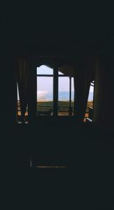 a window in a room with a view of the ocean at Royal cottage in Palolem