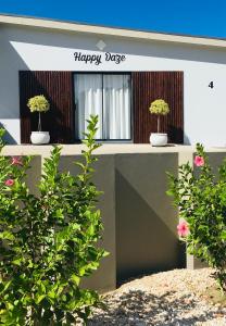 two potted plants sitting on top of a building at Happy Daze (Self catering) in Swellendam