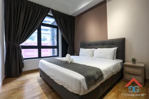 a bedroom with a large bed with a large window at Astoria Ampang By Grabstay in Kuala Lumpur