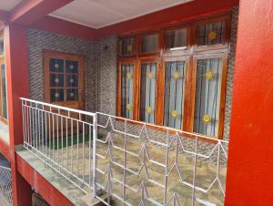 a balcony of a house with stained glass windows at Meraki Homestay in Shillong