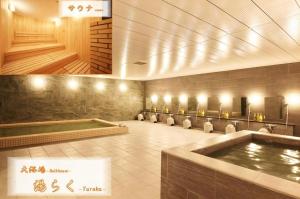 uma casa de banho com uma banheira de hidromassagem e uma piscina em HOTEL FUKURACIA OSAKA-BAY em Osaka