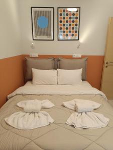 a large bed with two pillows on top of it at City Vibe-Sigrou 44 in Thessaloniki