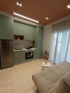 a living room with a bed and a kitchen at City Vibe-Sigrou 44 in Thessaloniki