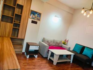 カトマンズにあるBeautiful 1 bedroom apartment in Sundhara Kathmanduのリビングルーム(ソファ、テーブル付)