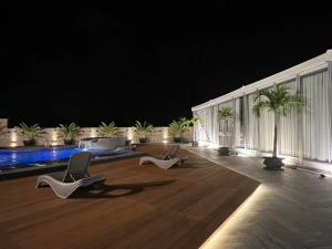 two chairs and a pool in a building at Grand Regal Hotel Davao in Davao City