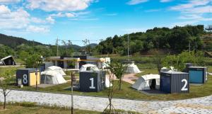 a park with domes and tents in front of a building at Starium Seocheon in Seocheon