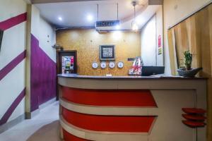 a lobby with a red and white striped wall at Hotel YSM Grand in Tezpur
