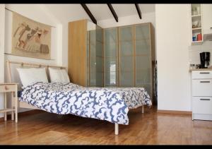 a bedroom with a bed and a dresser at Studio Room Ensuite by the Beach, Entire Independent Unit in Limassol