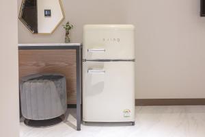 a refrigerator in a kitchen with a trash can at NOMAD HOTEL in Gimhae