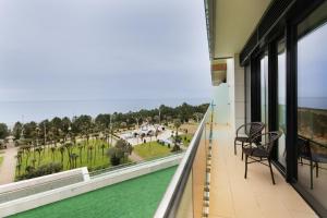 a balcony with a view of a park at Bellevue Residence Suites in Batumi