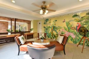 a living room with a flower mural on the wall at Salin Home Hotel Ramkhamhaeng in Bangkok