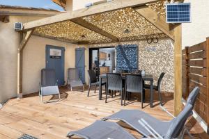 a patio with chairs and a table and a table and chairs at Plaines-Provence Spa&Sauna in Digne-les-Bains