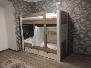 a wooden bunk bed in a room at KING Hostel in Center in Baku