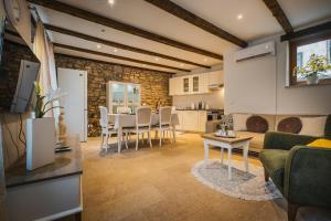 a kitchen and living room with a table and chairs at Casa ‘Crystal’ in Novigrad Istria