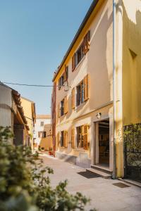 a building with a garage next to a street at Casa ‘Crystal’ in Novigrad Istria
