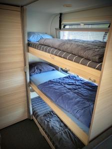 three bunk beds in a small room withermottermott at Glamping Beit Yanai in Bet Yannay