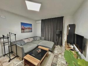 a living room with a couch and a television at Sandanski 2 Bedroom Apartment in Sandanski