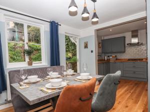 a kitchen and dining room with a table and chairs at Rose Cottage in Teignmouth