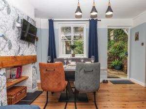 a dining room with a table and two chairs at Rose Cottage in Teignmouth