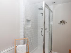 a shower with a glass door in a bathroom at Rose Cottage in Teignmouth
