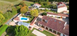 an aerial view of a house with a swimming pool at Poppy's Paradise in Bréville