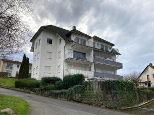 a large white building with a fence in front of it at Burgblick Pünderich in Pünderich