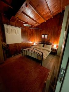 a bedroom with a bed in a wooden room at Gökler Çiftliğinde Ekolojik Tatil in Foca