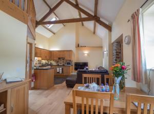 a kitchen and living room with a table and chairs at Eirlys Llanrhystud in Llanrhystyd