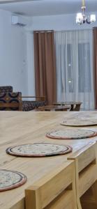 a room with three mats on a wooden table at Appartement Meuble SEED a Yaounde Odza in Yaoundé