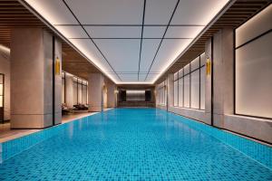 a swimming pool in a building with a ceiling at Sheraton Taiyuan in Taiyuan