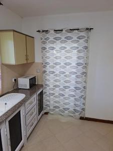 a kitchen with a shower curtain in a kitchen at Sea Lilly Beach in Palmar