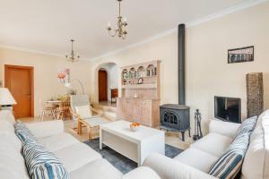 a living room with white furniture and a fireplace at Villa Nero by Villa Plus in Son Parc