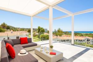 a living room with a couch and a view of the ocean at Villa Dolce Vita by Villa Plus in Alaior