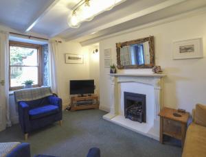 a living room with a fireplace and a television at Y Bwthyn Newport in Newport Pembrokeshire