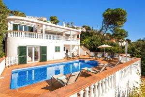 a villa with a swimming pool in front of a house at Villa Casa Bonita by Villa Plus in Alaior