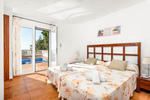 a bedroom with a large bed and a balcony at Villa Casa Bonita by Villa Plus in Alaior +30 photos