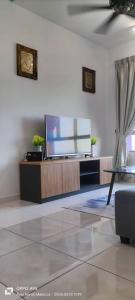 a living room with a flat screen tv on a stand at Hana Homestay The Heights Residence in Ayer Keroh