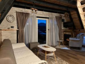 a living room with a couch and a table at Durmitorska zora in Žabljak