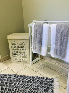 a towel rack in a bathroom with purple and white towels at Happy Daze (Self catering) in Swellendam