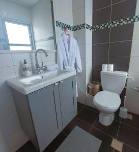 a bathroom with a sink and a toilet at Open-space apartment by the SEA in Ashdod