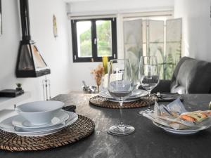 a table with plates and wine glasses on it at atardeceres lofts in Benaocaz
