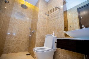 a bathroom with a toilet and a sink at Dorsett Residences Bukit Bintang in Kuala Lumpur