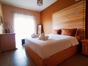a bedroom with a large bed with towels on it at Villa MATA - 600m² with Private Pool and Jacuzzi in Kalithies