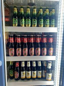 a refrigerator filled with lots of bottles of beer at Swiss Bonihouse Koh Yao Yai in Ban Phlu Nai