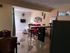a living room with a table and some chairs at Blue sea in Ruisseau Créole