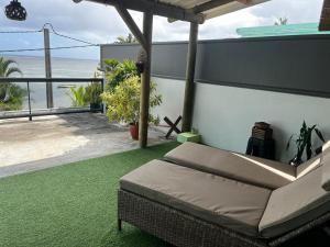 a bed on a balcony with a view of the ocean at Blue sea in Ruisseau Créole