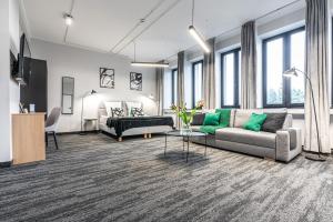 a living room with a couch and a bed at VANTA Business Center in Skawina